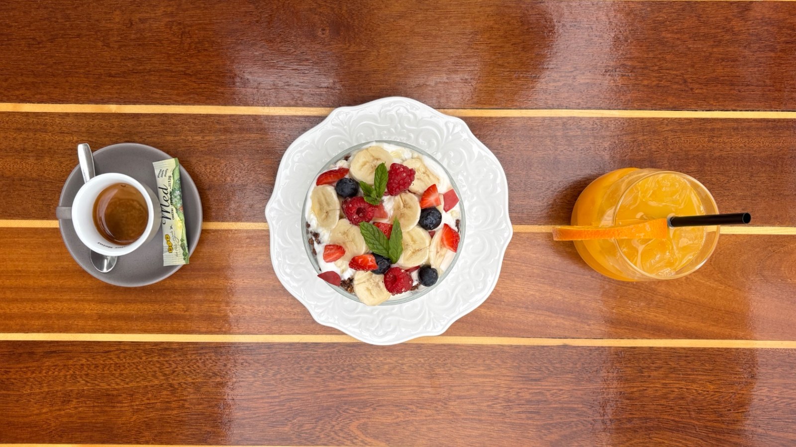 Finished breakfast: orange juice, yogurt granola bowl, espresso