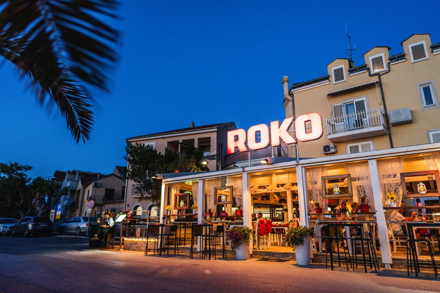 ROKO illuminated sign at blue hour over the terrace