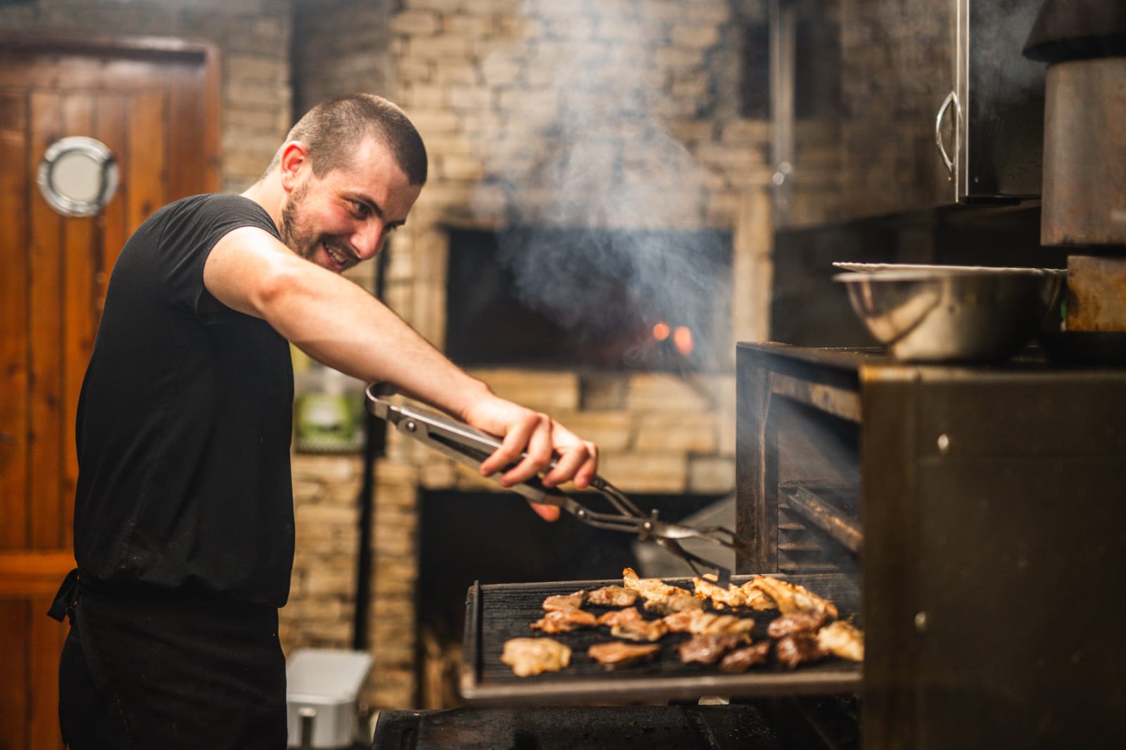 Chef tending the wood-fired grill