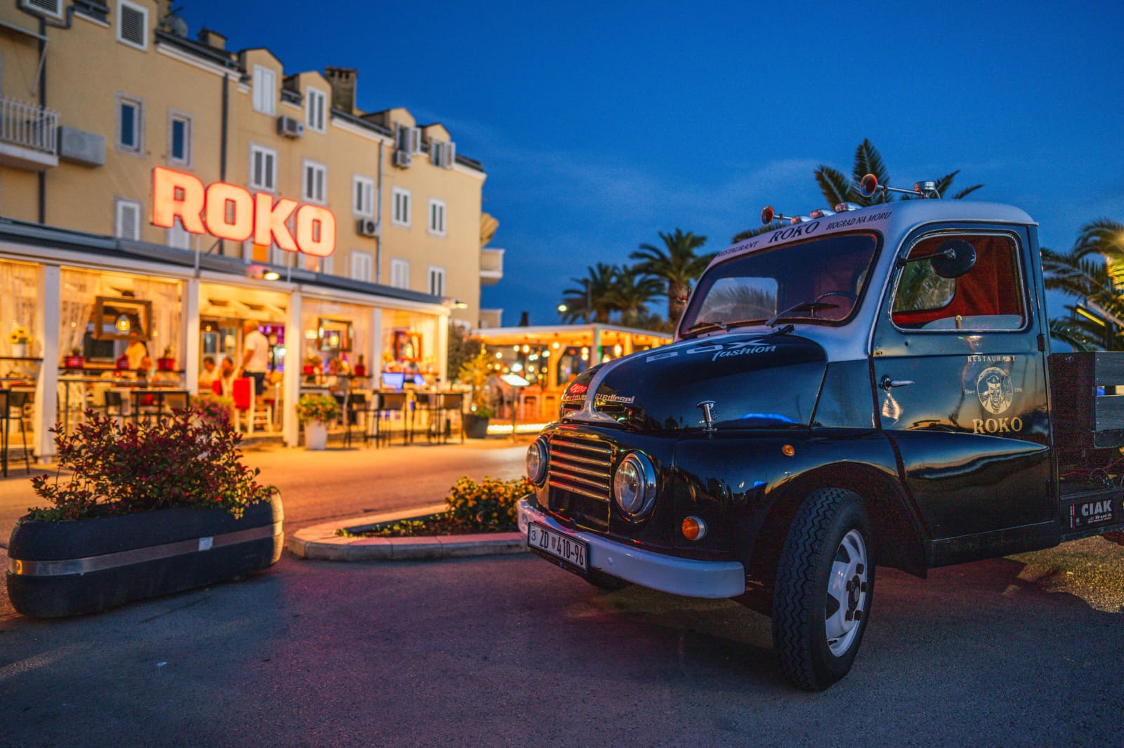 Vintage Roko truck in front of the illuminated Restaurant Roko terrace, Biograd na Moru