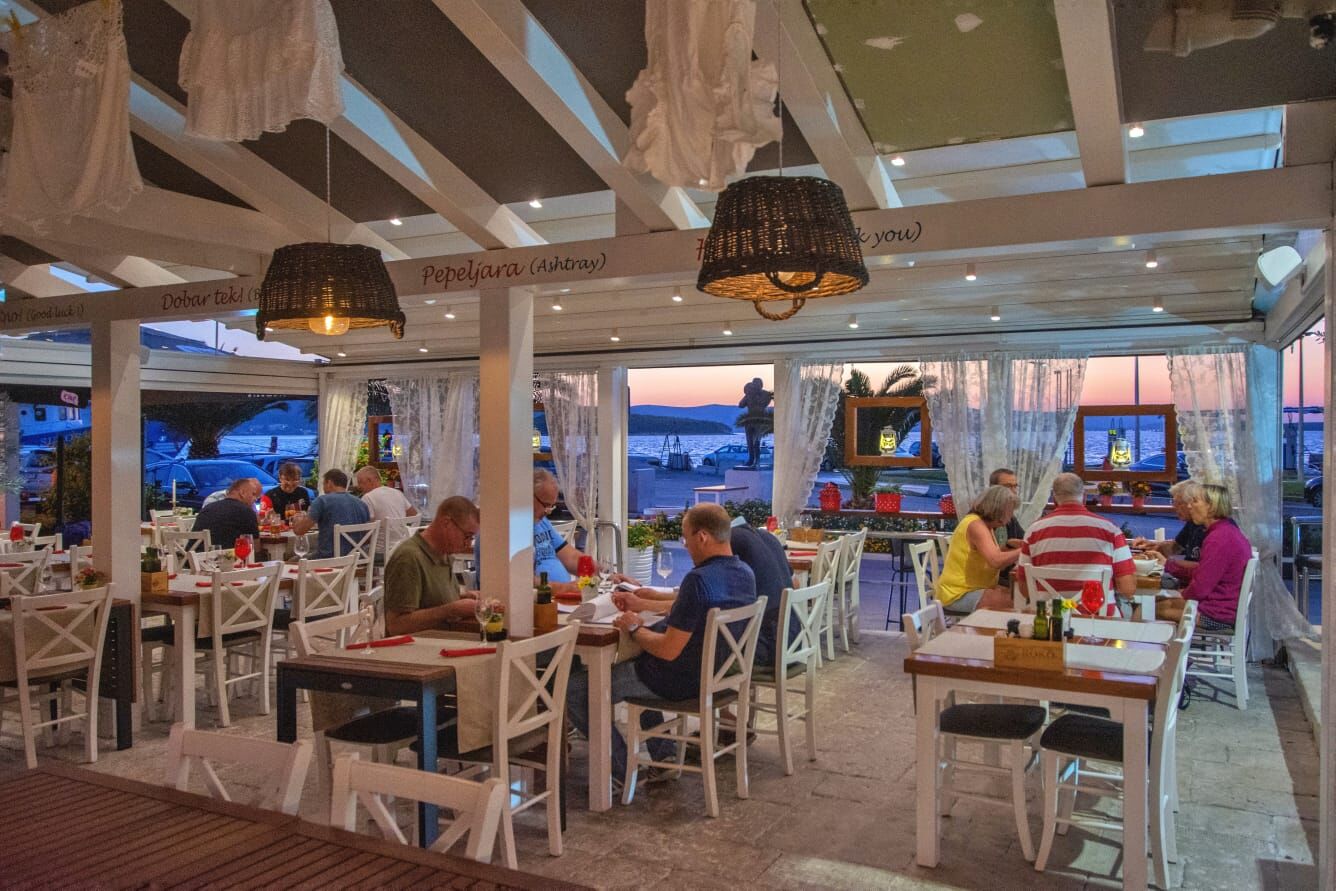 Terrace interior at sunset with sea view and hanging linens