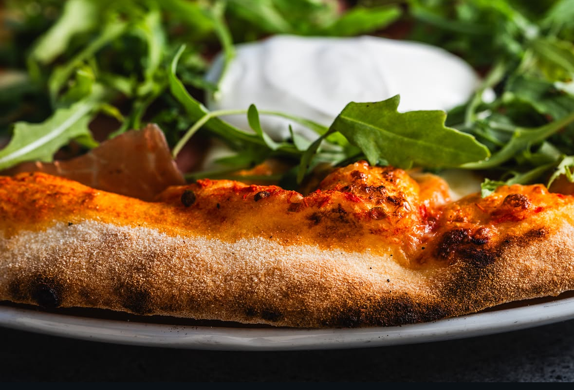 Wood-fired pizza crust, freshly baked