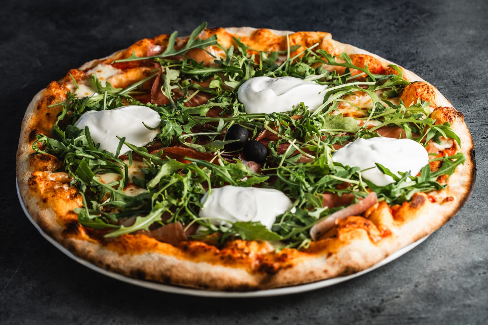Wood-fired pizza with arugula and mozzarella